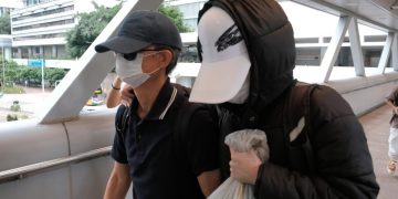 Hong Kong sentences father of wanted activist to 8 months in jail