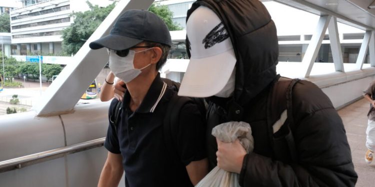 Hong Kong sentences father of wanted activist to 8 months in jail